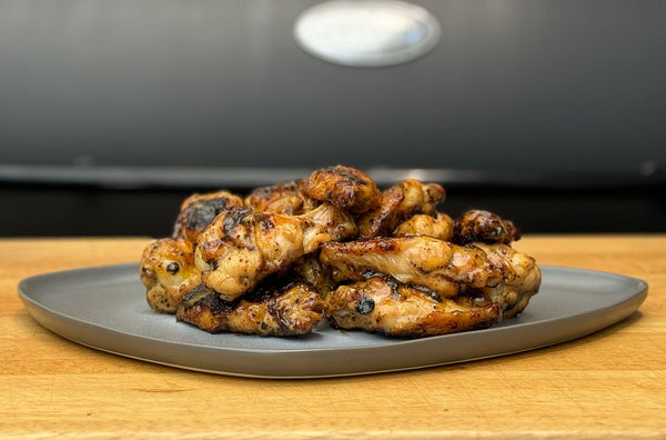 charred and grilled honey mustard chicken wings cooked on a louisiana grills wood pellet smoker