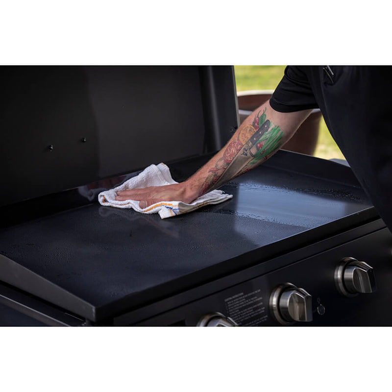 Louisiana Grills 4-Burner Gas Griddle with Ceramic Top. wiping down ceramic top with a cloth towel, rust free and non stick surface